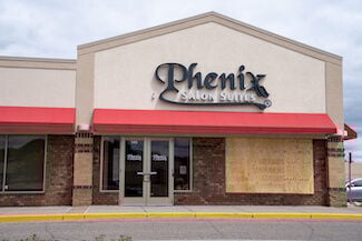 Minneapolis, Minnesota - May 29, 2020: A Phenix Salon Suites, a hair salon, is boarded up with plywood in anticipation of riots and looting in the death of George Floyd by Police Officers